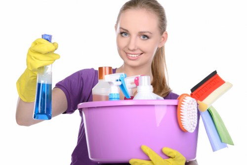 Cleaner preparing a guest-ready kitchen and living area in Brompton